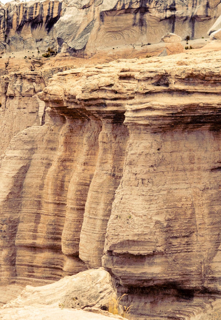 Eroded desert rock formations rising from dry sands